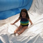 Happy Girl Enjoying Summer Camp Water Slide